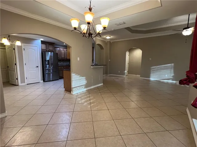 a view of a livingroom with a chandelier furniture and a chandelier