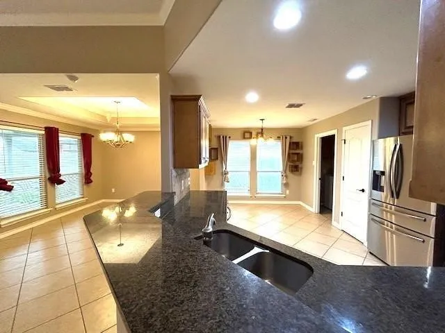 a large kitchen with stainless steel appliances granite countertop a sink and cabinets