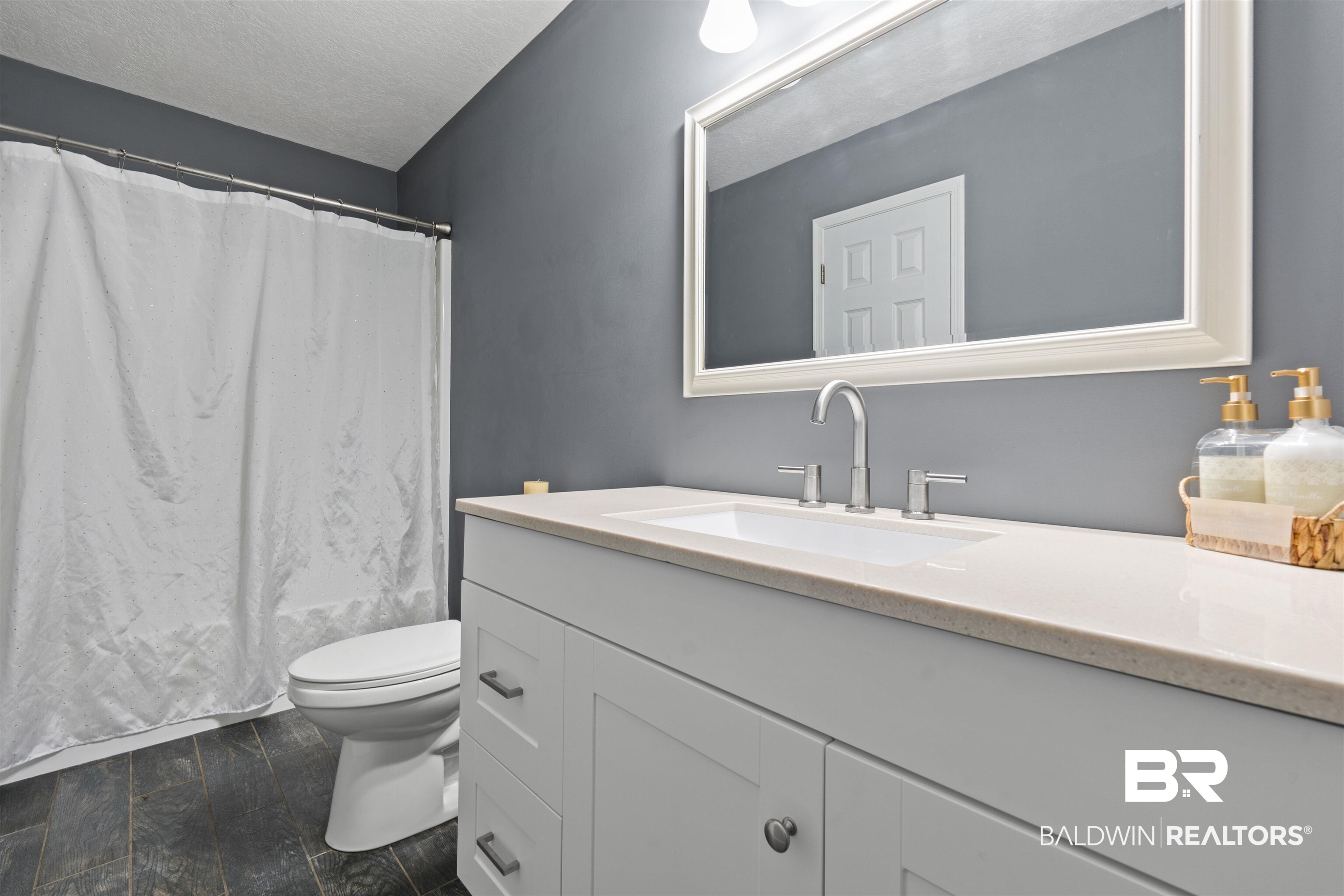 2000 Campfire Drive Semmes, AL 36575 - Photo 14 of 26 Bathroom featuring tile patterned floors, toilet, vanity, and a textured ceiling