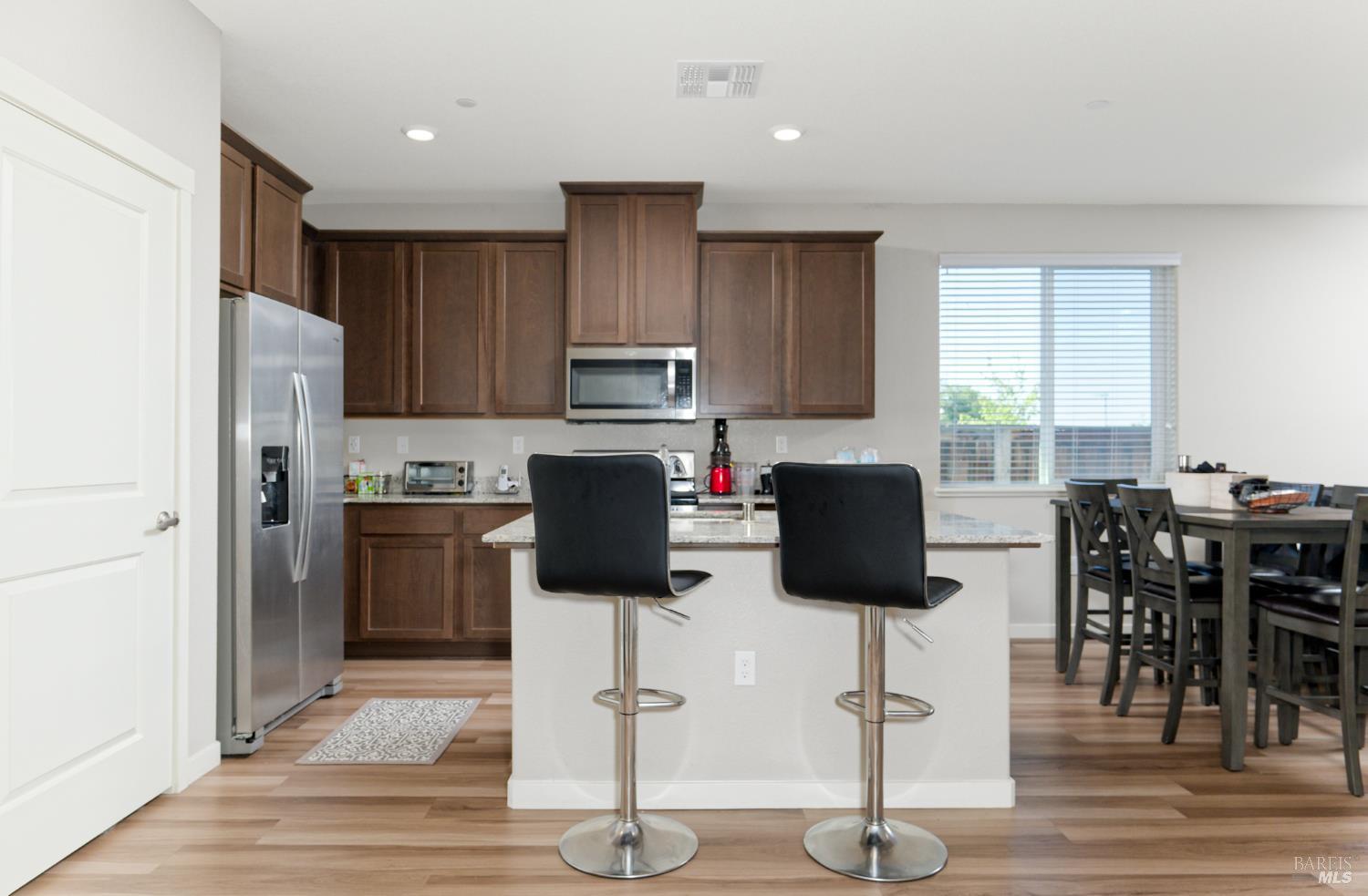 2211 Stars Drive Rio Vista, CA 94571 - Photo 10 of 24 a kitchen with stainless steel appliances kitchen island granite countertop a refrigerator and cabinets