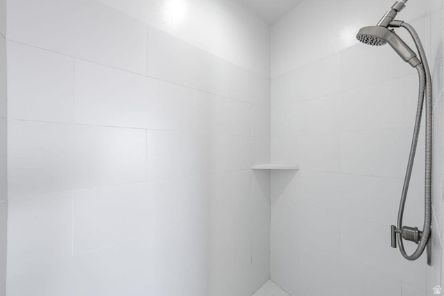 5963 Flattop Drive St. George, UT 84790 - Photo 25 of 45 Shower stall featuring white tile walls, a built-in corner shelf, and a brushed nickel showerhead with a handheld sprayer