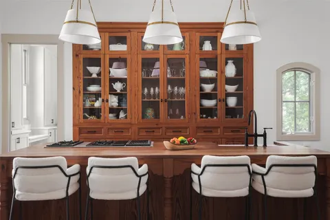 a dining room with chairs and chandelier