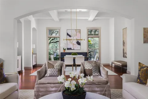 a living room with furniture a chandelier and a window