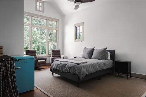 a spacious bedroom with a bed and a window