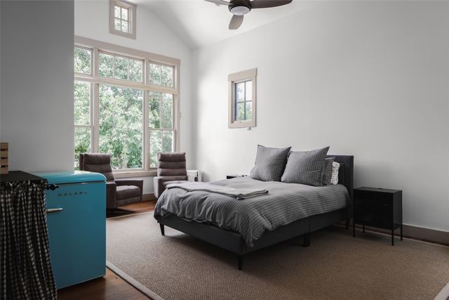 a spacious bedroom with a bed and a window