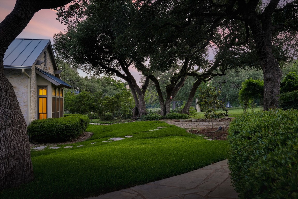 3020 Maravillas Loop Austin, TX 78735 - Photo 8 of 35 a view of a white house next to a yard with big trees