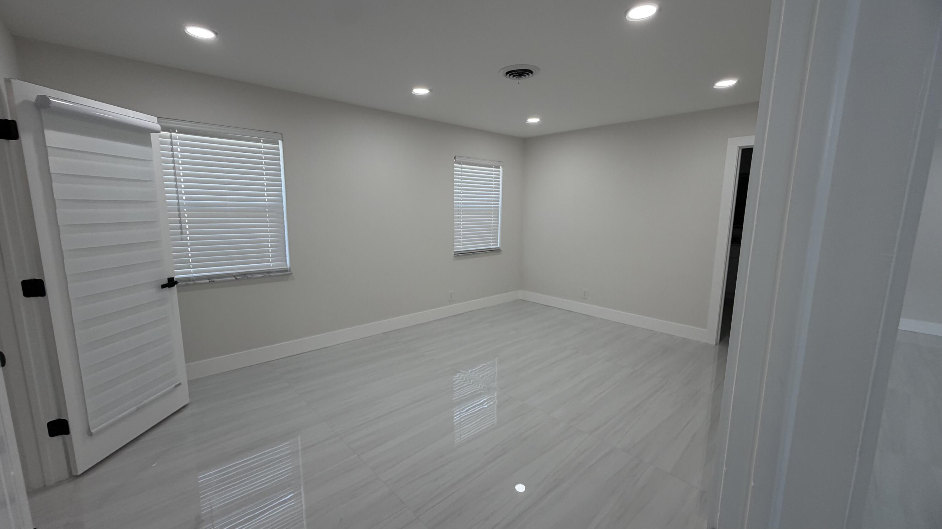 2521 Northeast 45th Street Lighthouse Point, FL 33064 - Photo 10 of 25 an empty room with wooden floor and windows