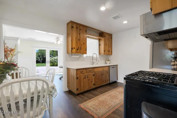 a view of a room with furniture and wooden floor