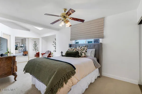 a bedroom with furniture and a flat screen tv