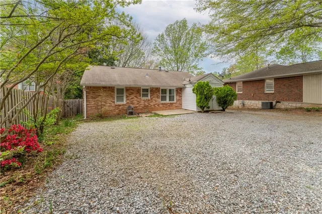 a view of a house with a yard and potted plants