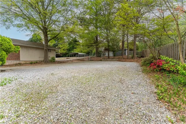 a backyard of a house with flower plants