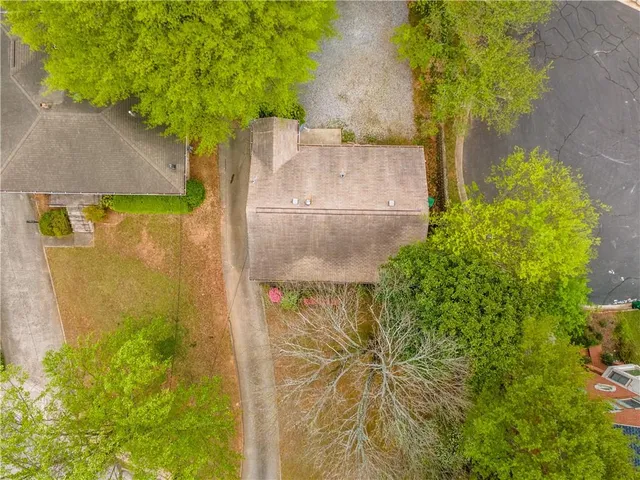 an aerial view of a house with a yard