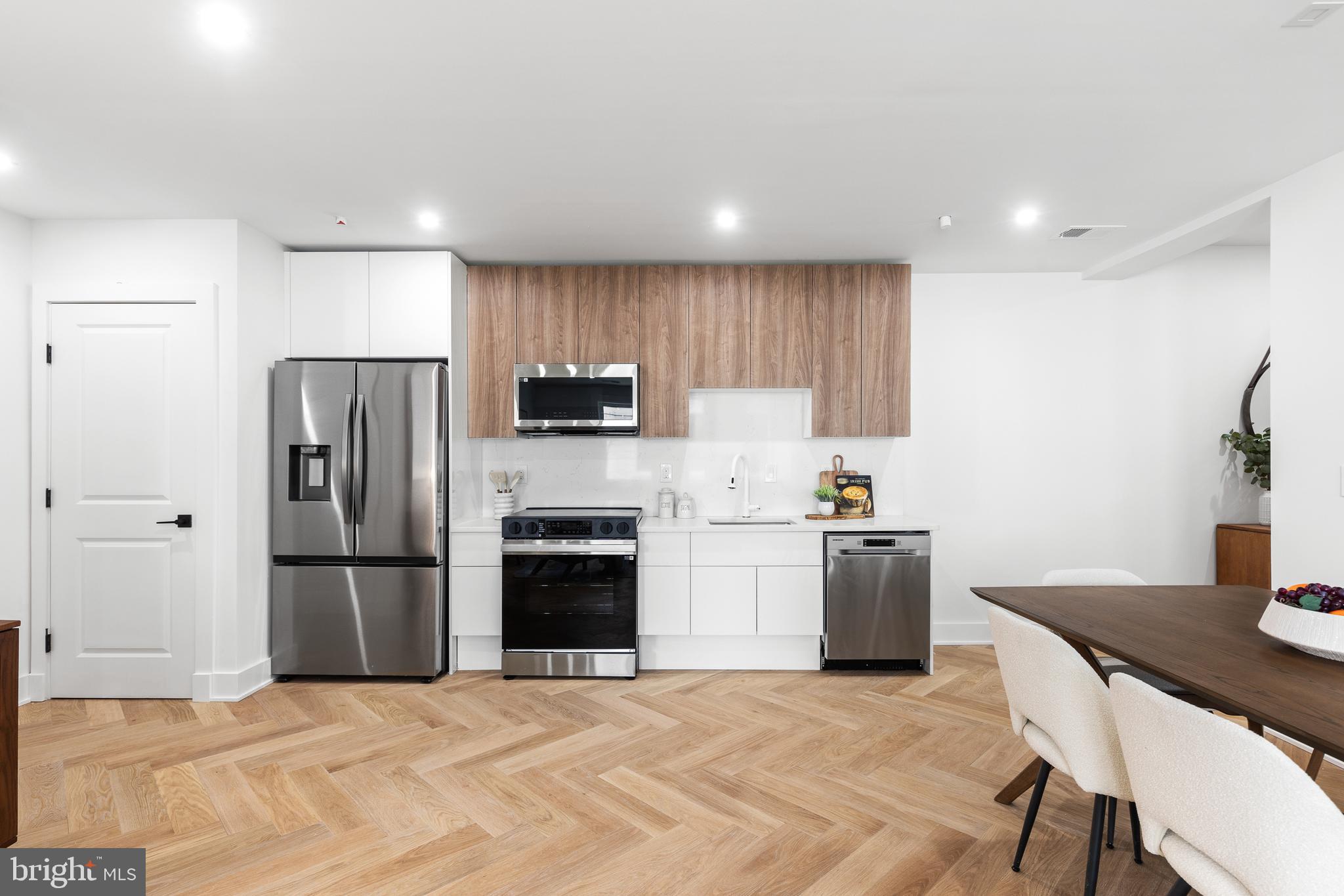 1124 Florida Street Northeast, Unit 210 Washington, DC 20002 - Photo 22 of 26 a kitchen with stainless steel appliances granite countertop a refrigerator stove microwave and sink