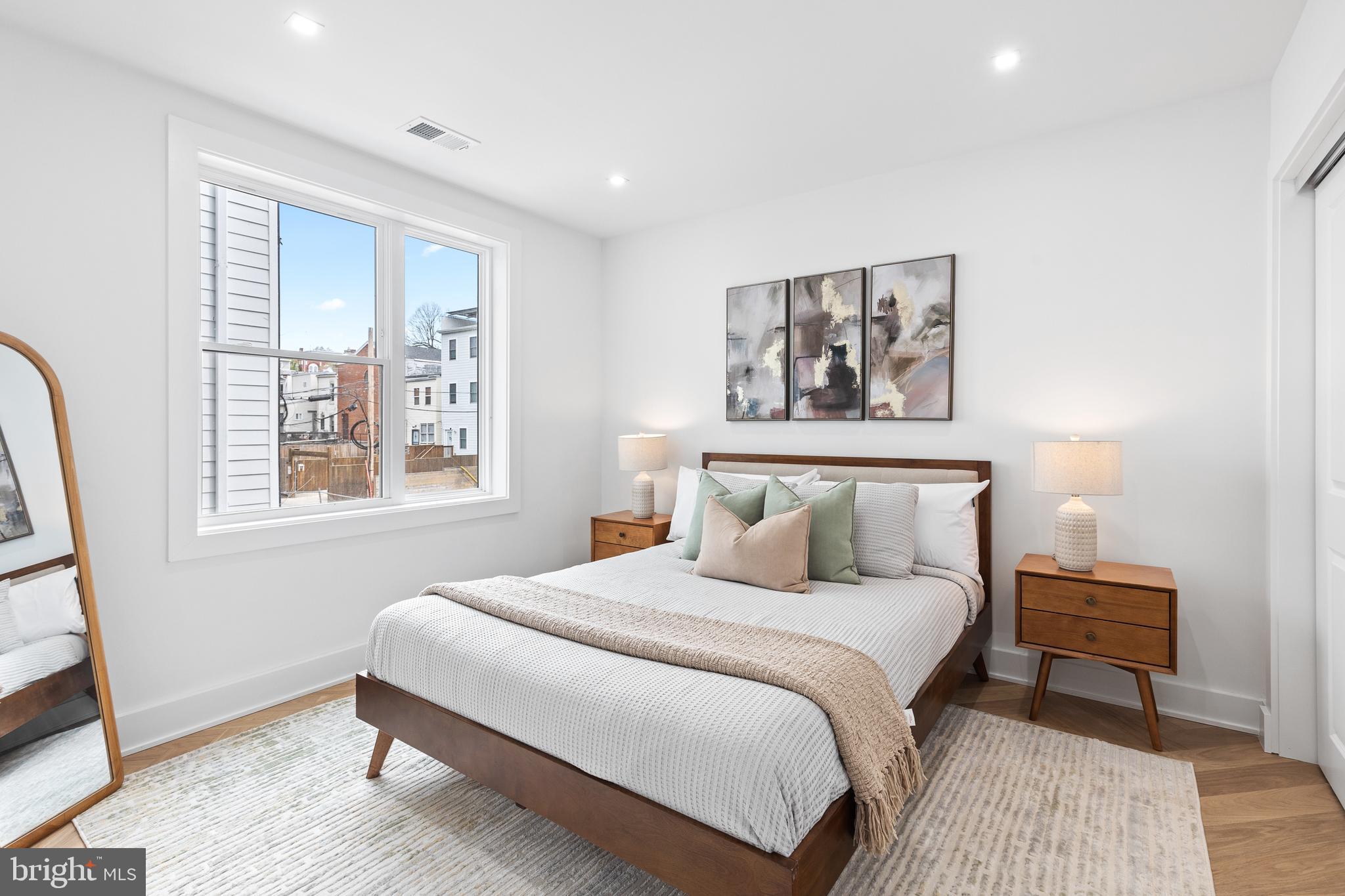 1124 Florida Street Northeast, Unit 210 Washington, DC 20002 - Photo 23 of 26 a bedroom with a bed and a window