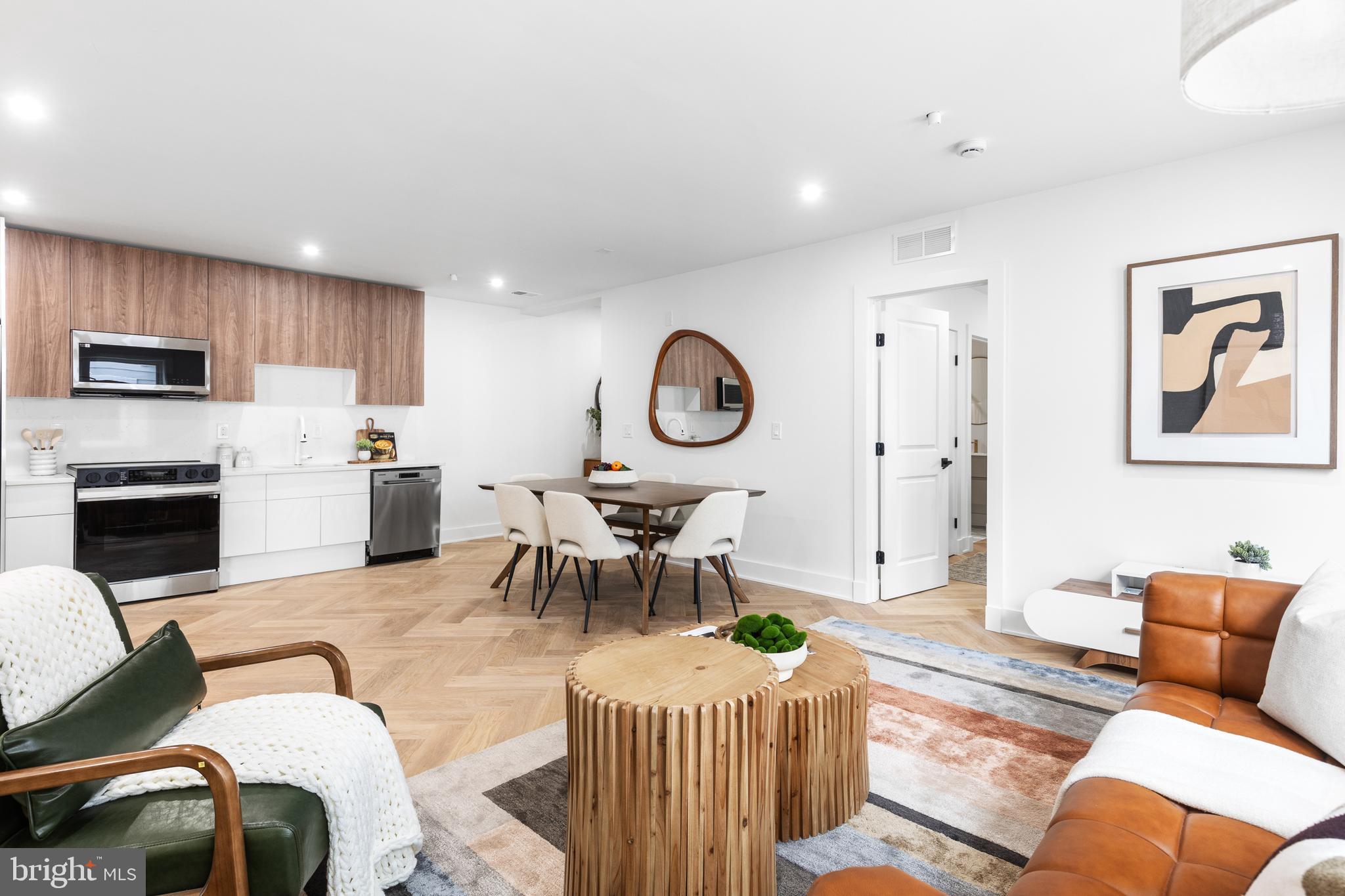 1124 Florida Street Northeast, Unit 210 Washington, DC 20002 - Photo 4 of 26 a living room with furniture a fireplace and a large window