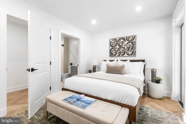 a bedroom with a bed and a table