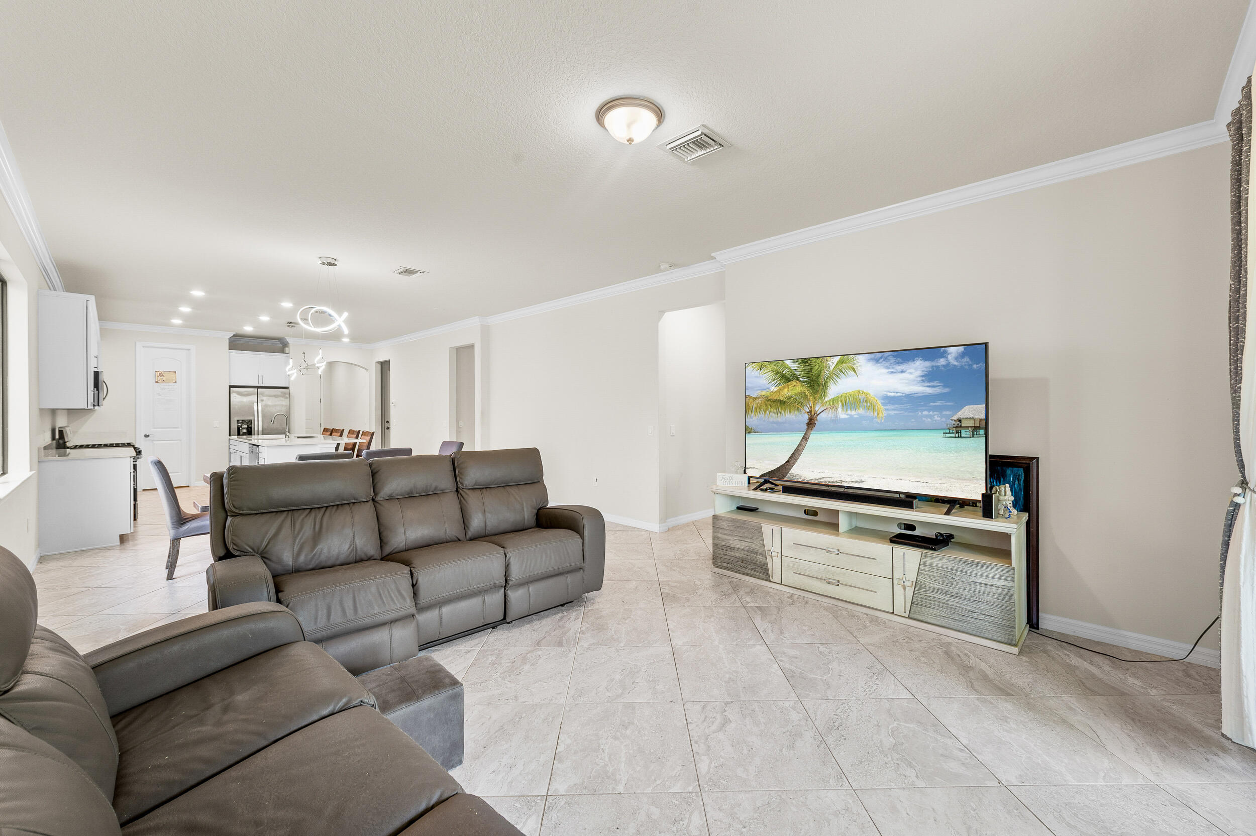 4762 Roldan Court Lake Worth, FL 33467 - Photo 16 of 41 a living room with furniture and a flat screen tv