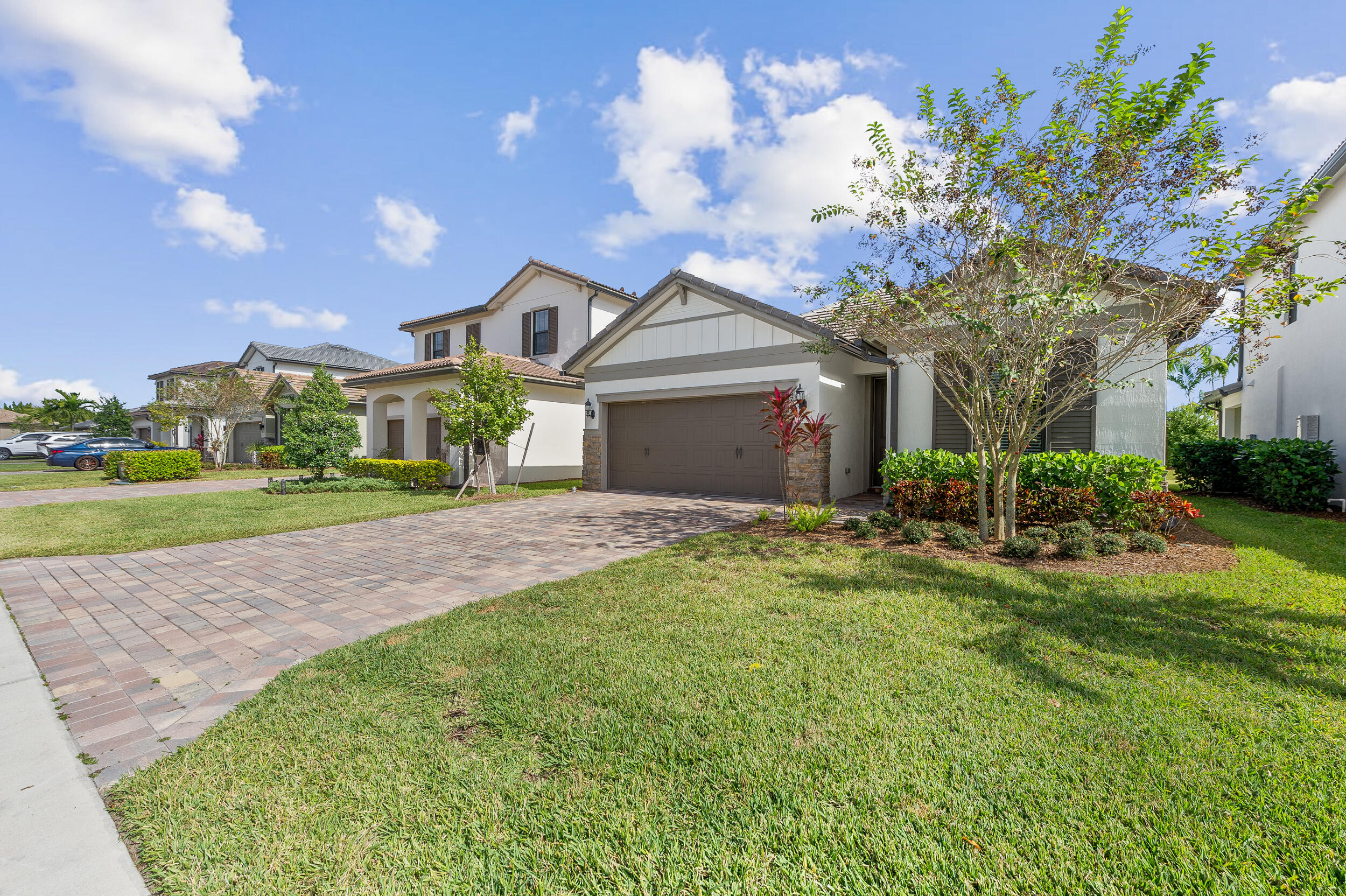4762 Roldan Court Lake Worth, FL 33467 - Photo 2 of 41 a front view of a house with a yard and garage