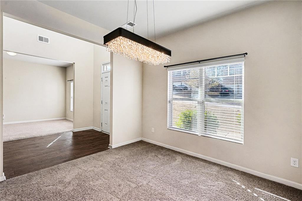 11046 Genova Terrace Hampton, GA 30228 - Photo 11 of 38 an empty room with wooden floor and windows