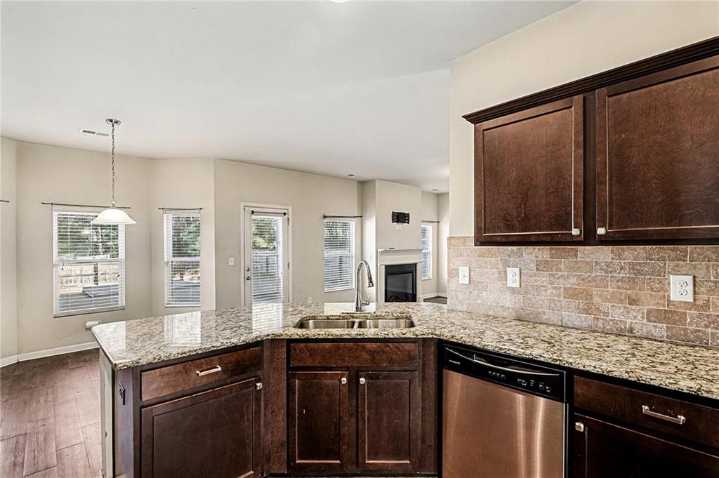 11046 Genova Terrace Hampton, GA 30228 - Photo 15 of 38 a kitchen with granite countertop a sink and a stove