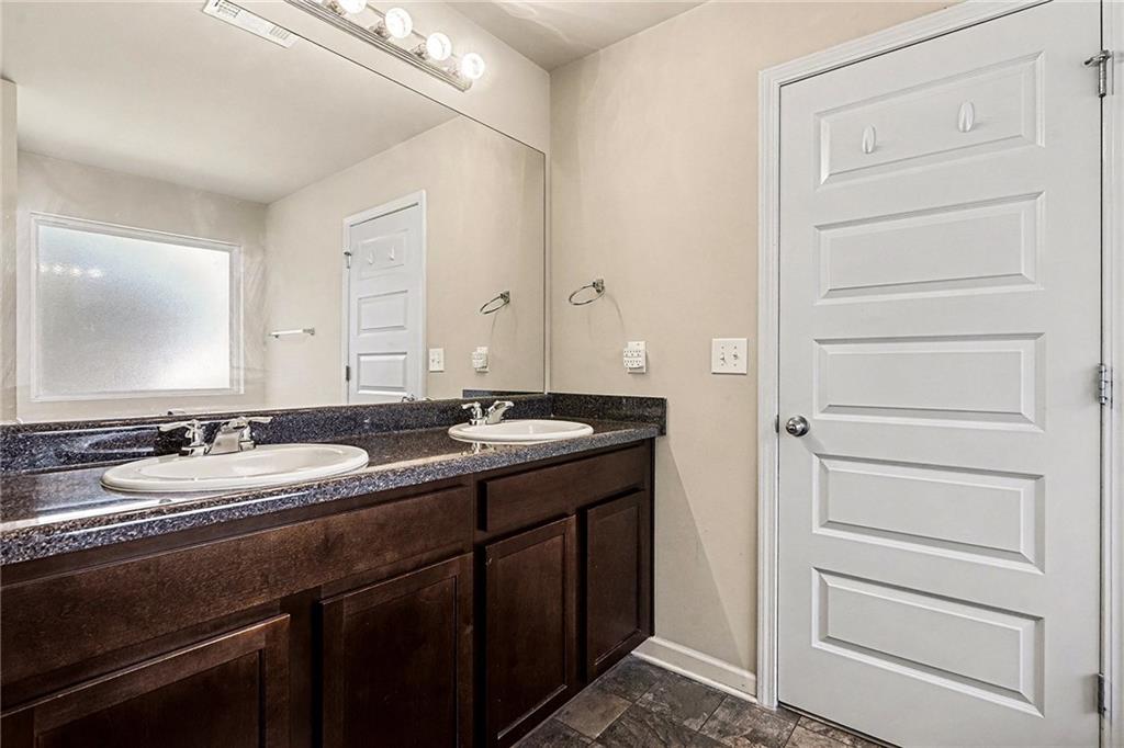 11046 Genova Terrace Hampton, GA 30228 - Photo 19 of 38 a bathroom with a sink and a mirror