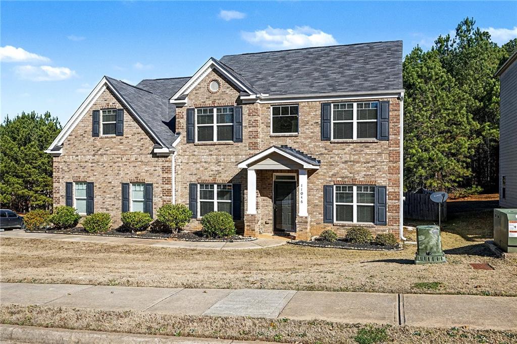 11046 Genova Terrace Hampton, GA 30228 - Photo 2 of 38 a front view of a house with garden