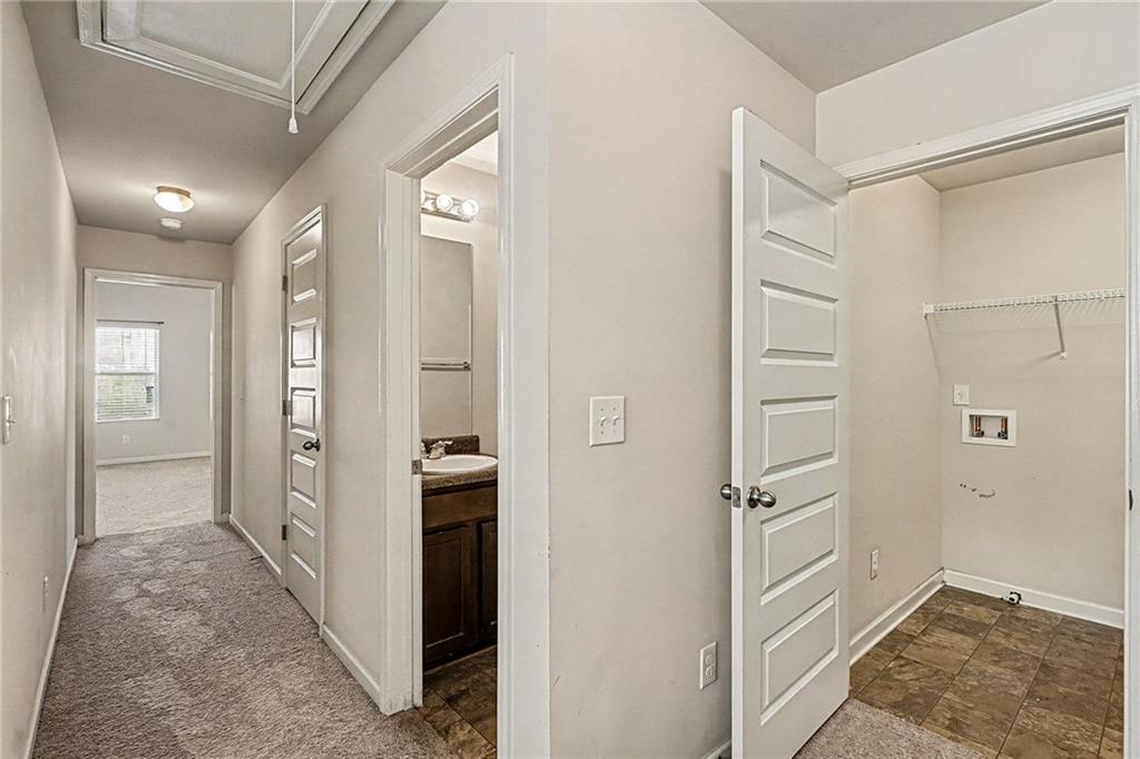 11046 Genova Terrace Hampton, GA 30228 - Photo 23 of 38 a view of a hallway with closet and wooden floor