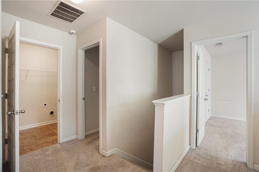 11046 Genova Terrace Hampton, GA 30228 - Photo 24 of 38 a view of a hallway to rooms