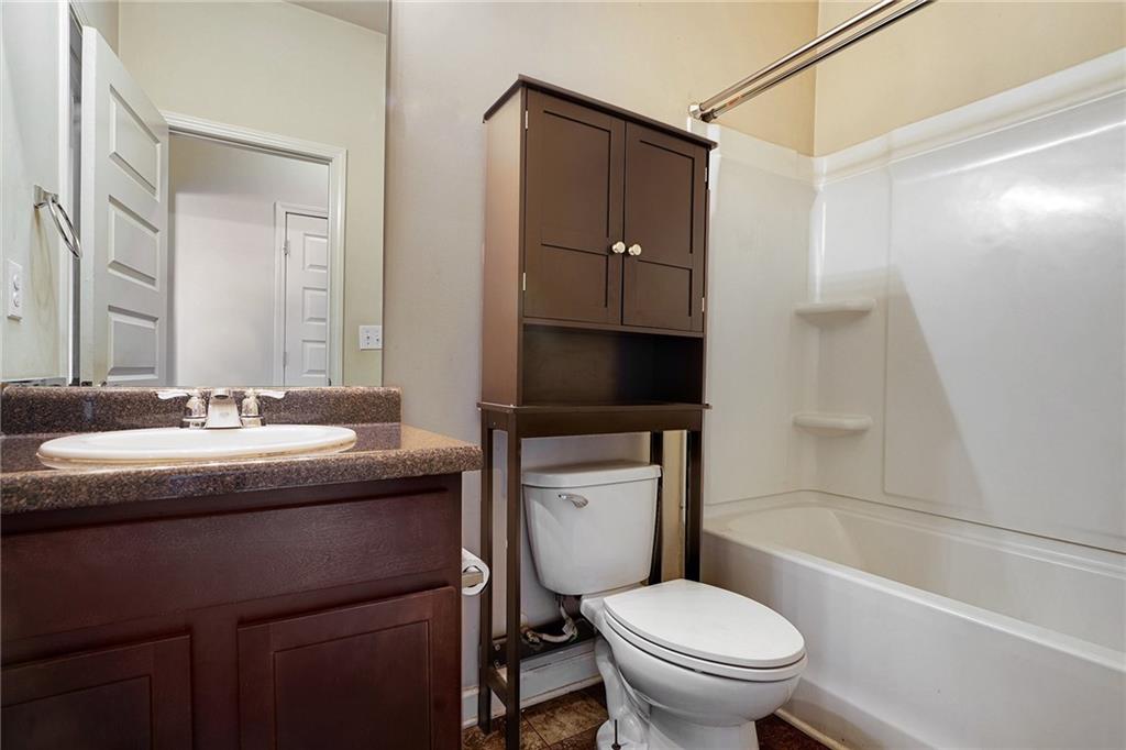 11046 Genova Terrace Hampton, GA 30228 - Photo 25 of 38 a bathroom with a granite countertop sink toilet and shower
