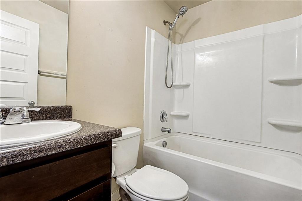 11046 Genova Terrace Hampton, GA 30228 - Photo 28 of 38 a bathroom with a granite countertop sink toilet and shower
