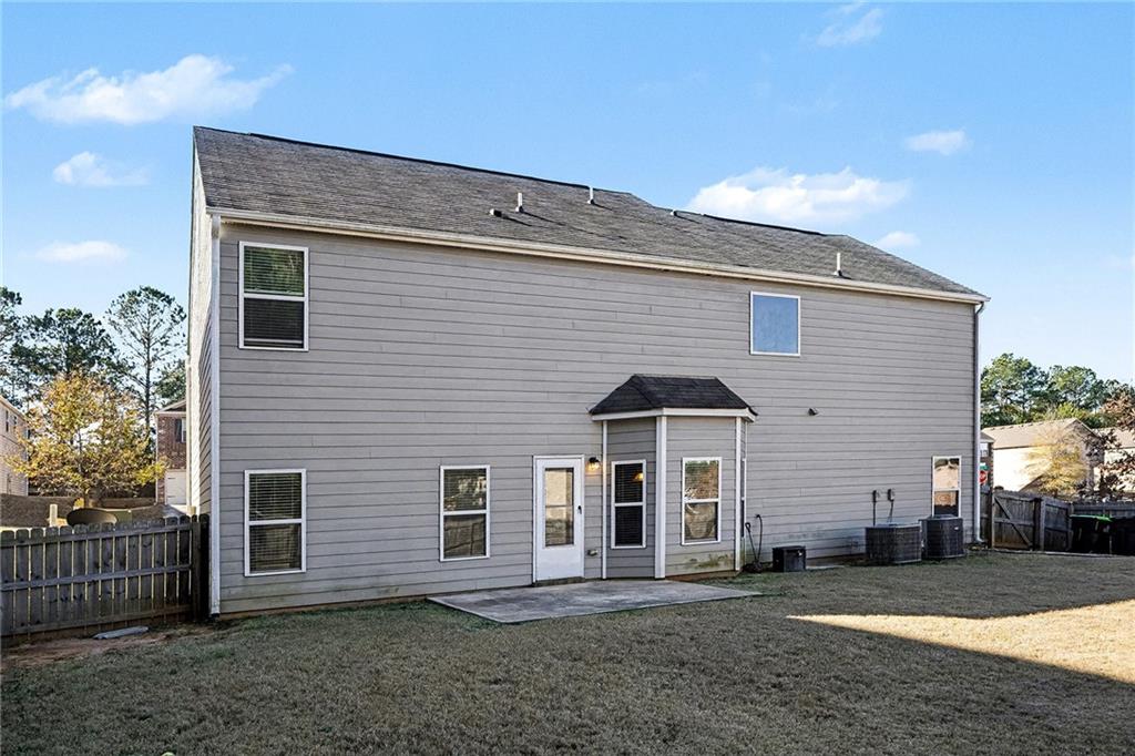 11046 Genova Terrace Hampton, GA 30228 - Photo 36 of 38 a front view of a house with a yard