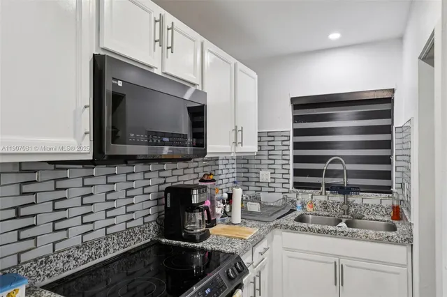 a kitchen with a sink and cabinets