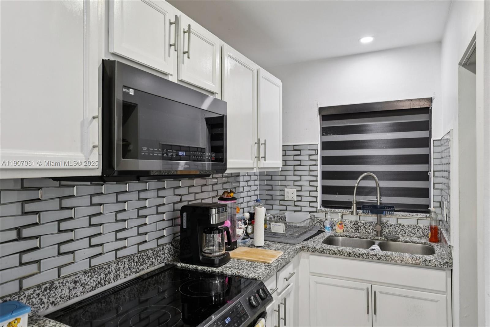 1630 West 46th Street, Unit 208F Hialeah, FL 33012 - Photo 13 of 21 a kitchen with a sink and cabinets