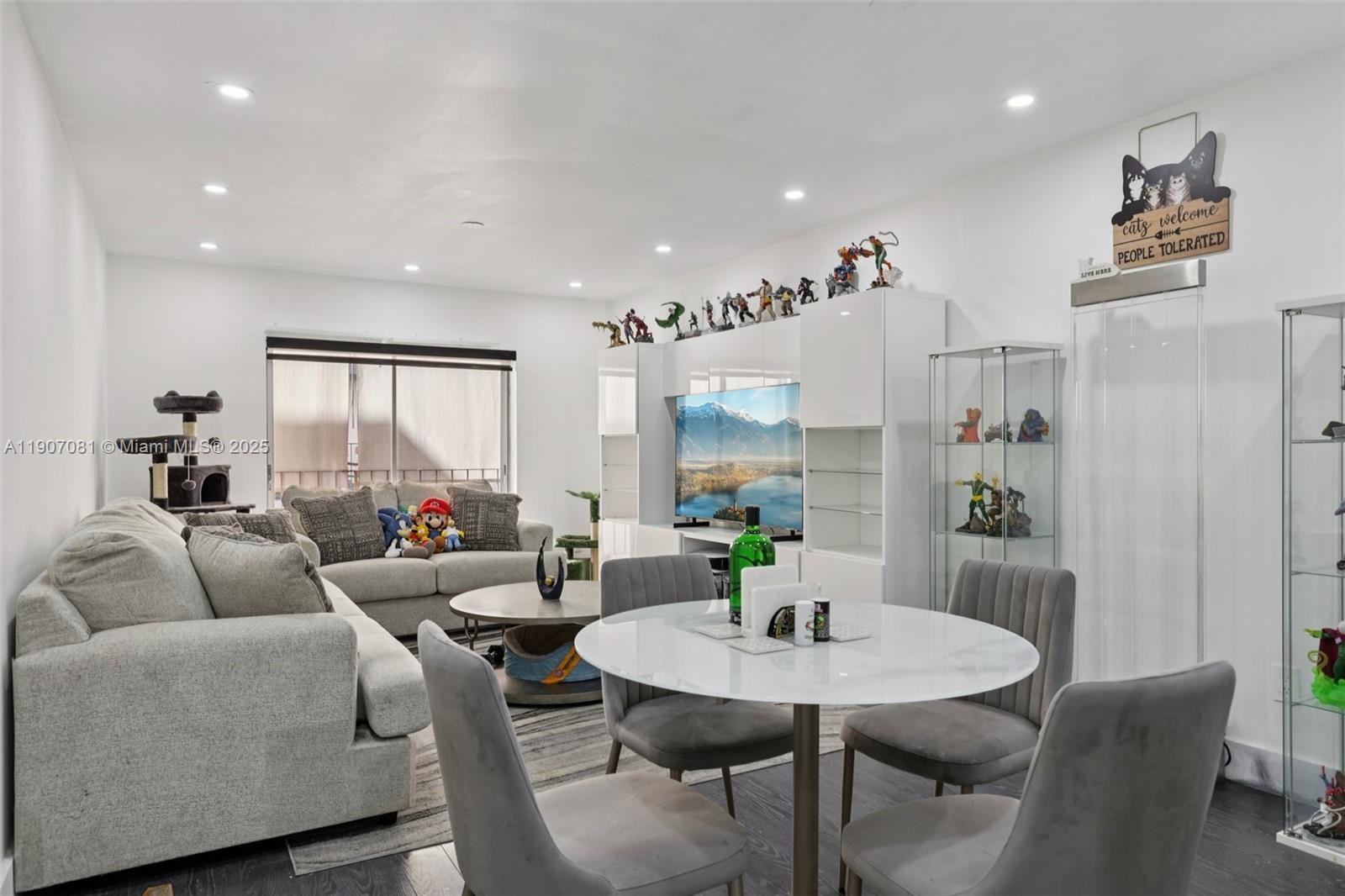 1630 West 46th Street, Unit 208F Hialeah, FL 33012 - Photo 15 of 21 a living room with furniture and a table