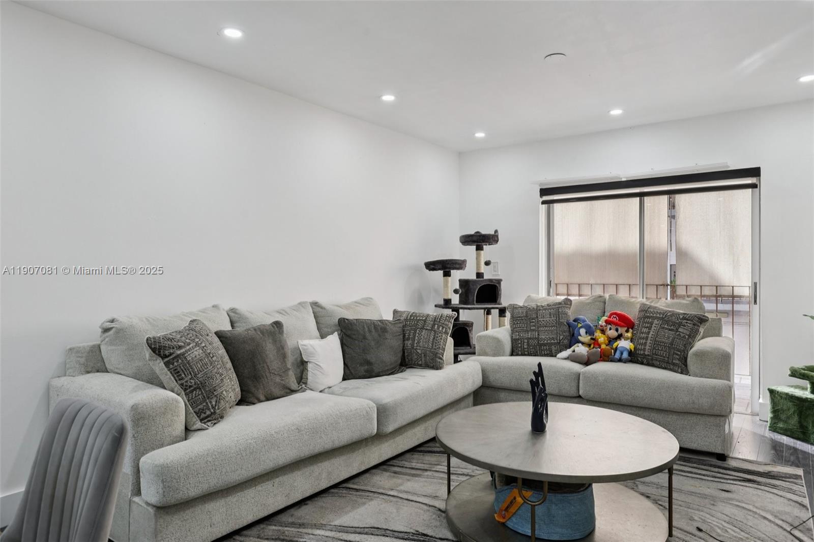 1630 West 46th Street, Unit 208F Hialeah, FL 33012 - Photo 17 of 21 a living room with furniture and a large window