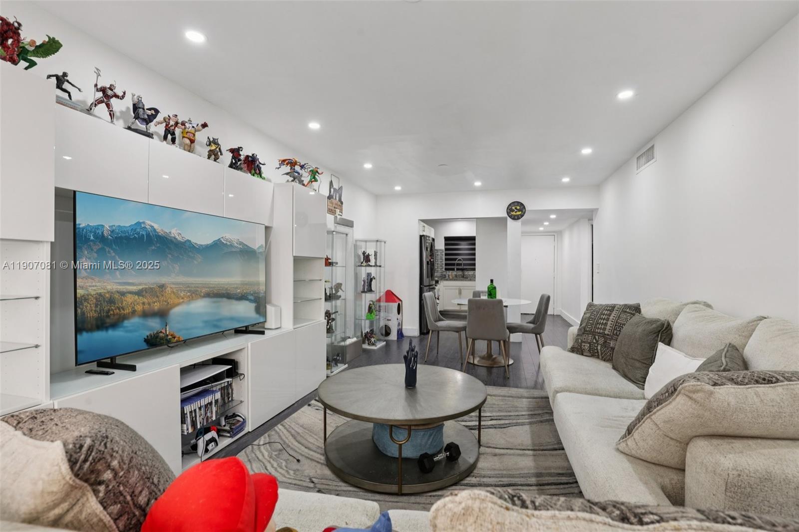 1630 West 46th Street, Unit 208F Hialeah, FL 33012 - Photo 2 of 21 a living room with furniture and a flat screen tv