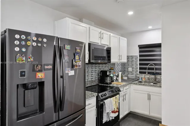 a kitchen with stainless steel appliances a refrigerator stove and microwave
