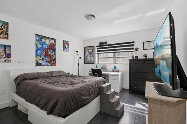 a bedroom with a bed and dresser