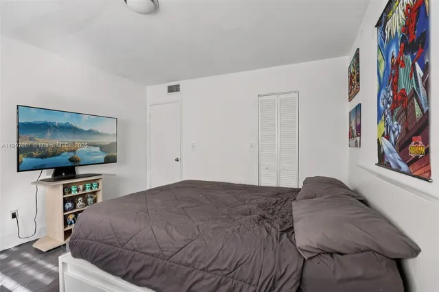 a bedroom with a bed and a flat screen tv