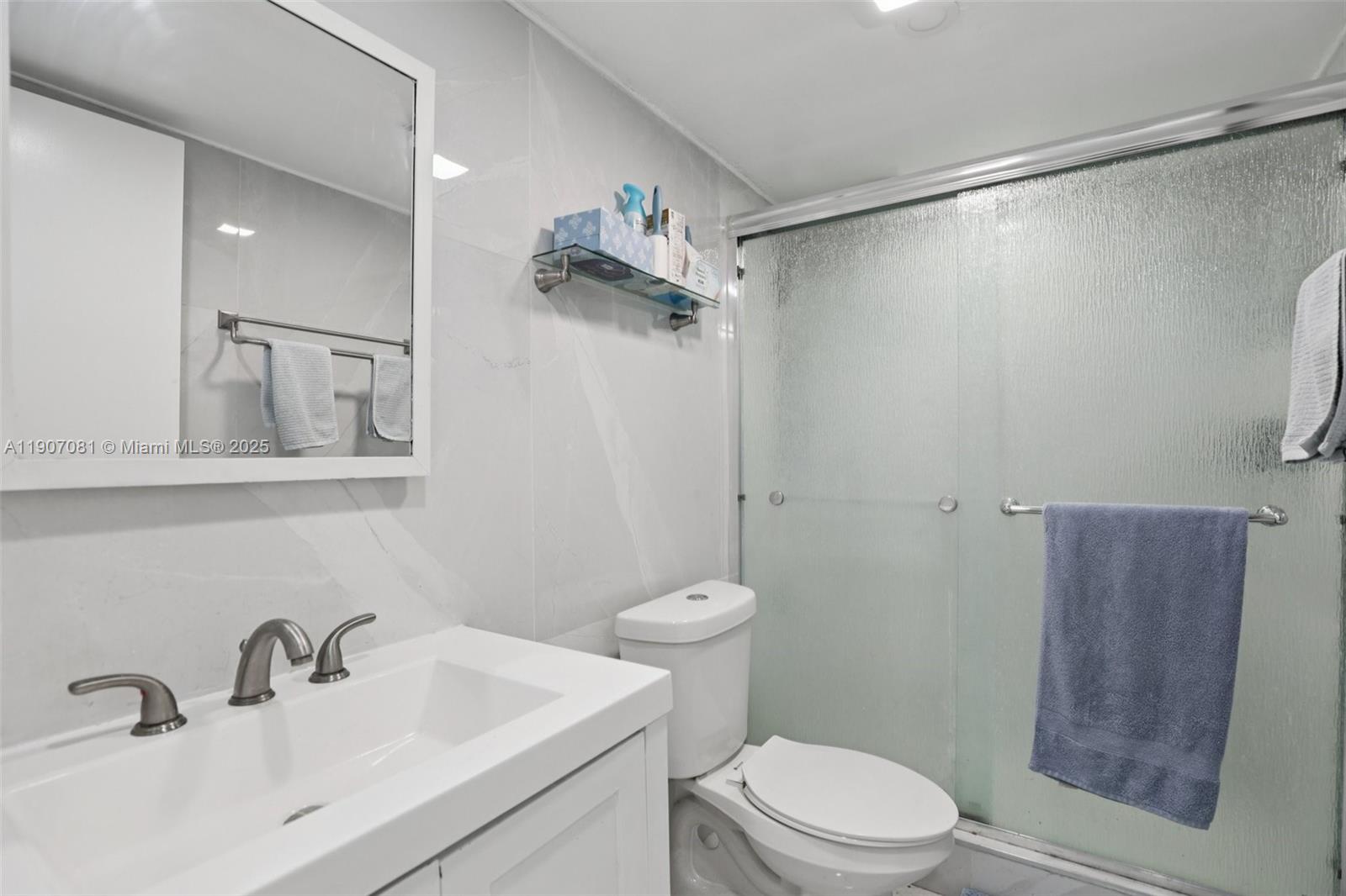 1630 West 46th Street, Unit 208F Hialeah, FL 33012 - Photo 9 of 21 a bathroom with a sink a toilet and shower