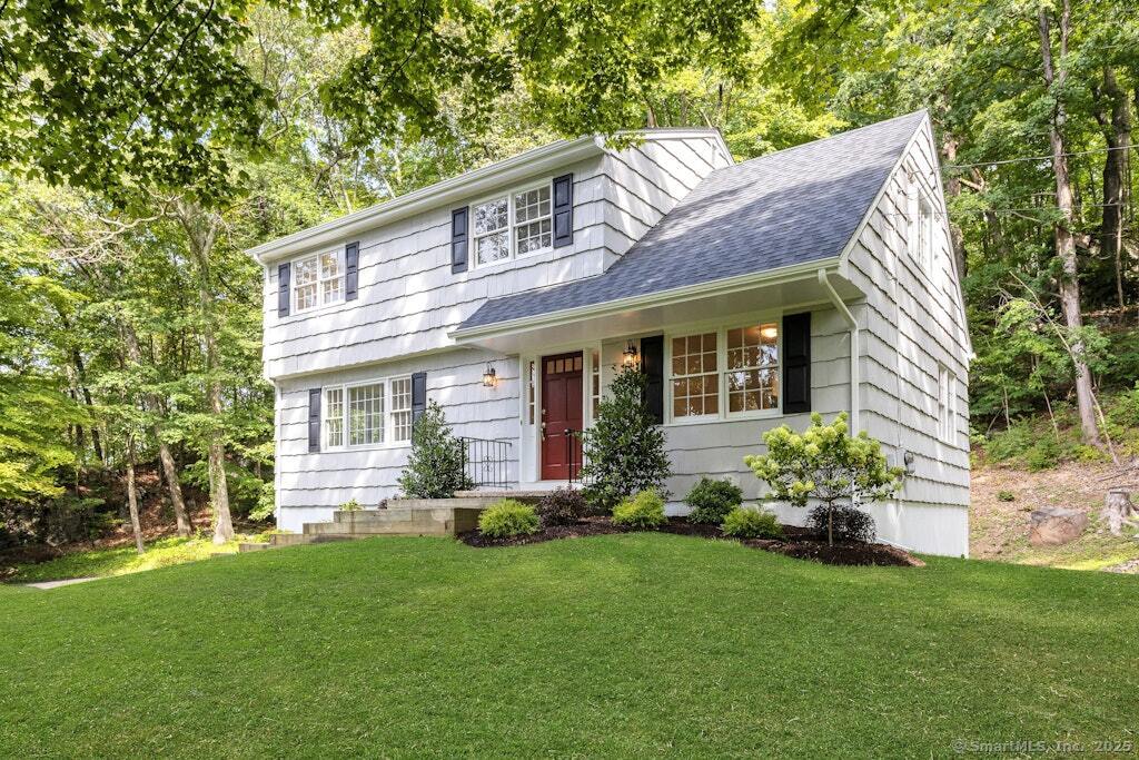 a front view of house with yard and green space