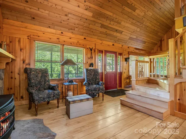 a living room with furniture and large windows