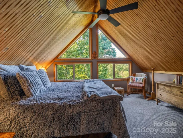 a bed sitting in a bedroom next to a window