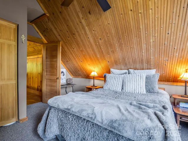 a bed sitting in a bedroom next to a window