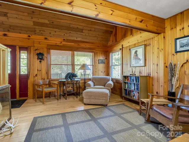 a living room with furniture gym equipment and a large window