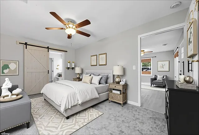 a bedroom with a bed couch and window