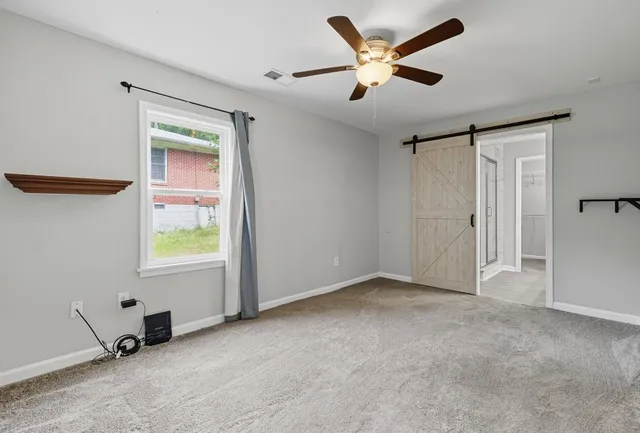 a view of an empty room with a window