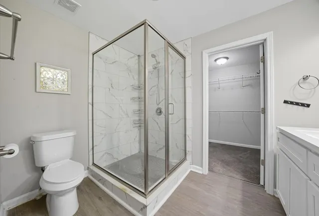 a bathroom with a shower a toilet and a sink