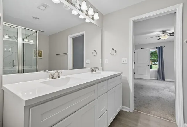 a spacious bathroom with a double vanity sink and a mirror