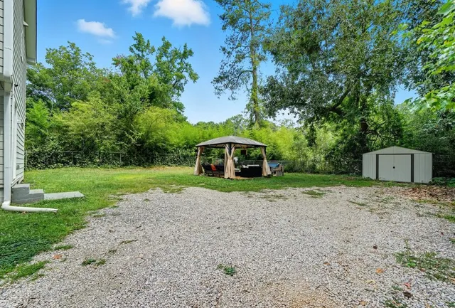 a house with green field in front of it